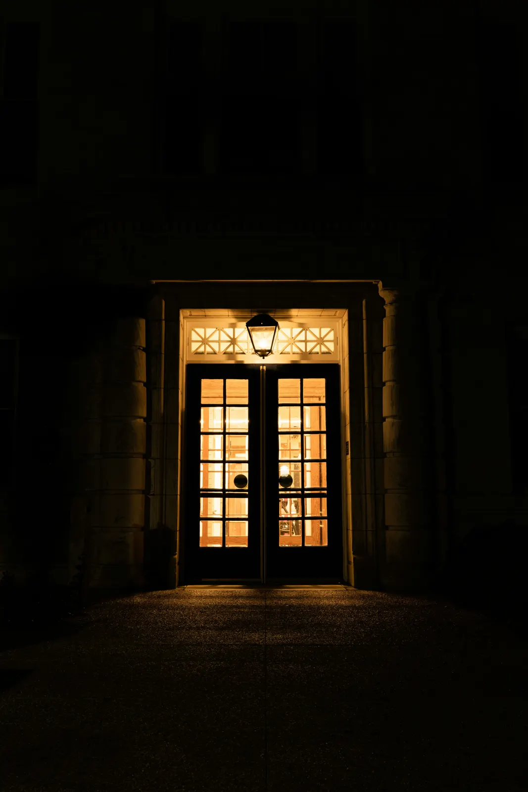 Front door of a house with a warm light on at night